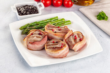 Tasty grilled pork medallion with bacon