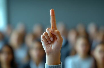 Raised Hand in Classroom Setting with Blurred Audience Focus