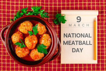 Calendar opened at the date March 9 and kottbullar meatballs in red sauce. National Meatball Day