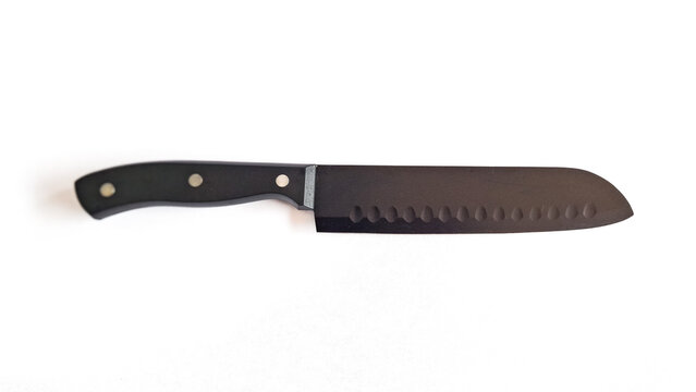 Sharp black santoku chef knife isolated on white, high quality stainless steel, plastic handle. top view