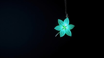 Glowing Teal Leaf Pendant Necklace on Black Background