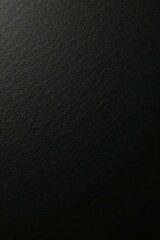 Black textured paper with subtle light reflections, elegant, charcoal
