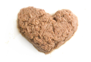 raw tuna in heart shape on white background