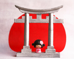 Torii arch with Japanese flag in the background