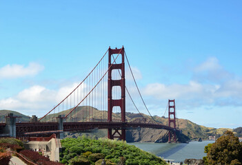 Beautiful view of famous Golden Gate Bridge with blue sky and clouds on a sunny day in summer San Francisco Bay Area California USA