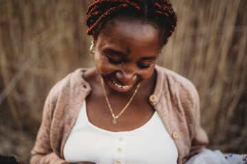 Happy black woman smiling looking down