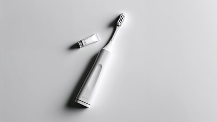 Fototapeta premium Toothbrush and Small Toothpaste Tube on a White Surface, Clean and Simple Oral Care Essentials