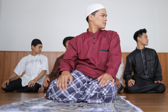 Young Man Leading Muslim Prayer Finishing Salah By Performing Taslim