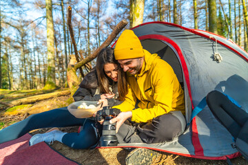 Hikers reviewing photos of mushrooms during camping trip