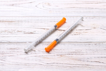 Top view of insulin syringe prepared for injection at wooden background. Diabetes concept with copy...