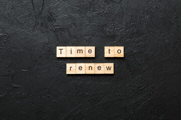 time to renew word written on wood block. time to renew text on table, concept