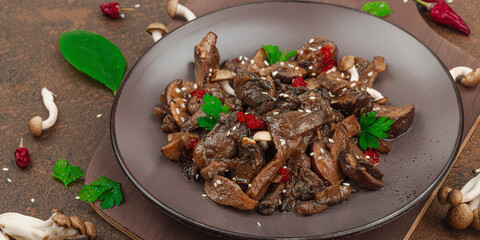 Delicious Shimeji mushrooms with chili pepper, sesame seeds and greens. Healthy Umami vegan food