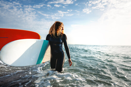 Woman with surfing board at beach, sea and ocean for summer holiday, travel adventure or hobby.
