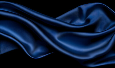 Obraz premium Elegant Dark Blue Satin Fabric Draped on Black Background