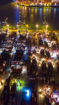 night illuminated hong kong city famous cargo working port aerial vertical timelapse panorama 4k hing kong