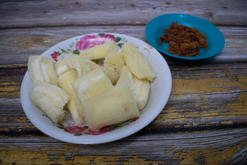 Soft boiled cassava pieces served with brown sugar