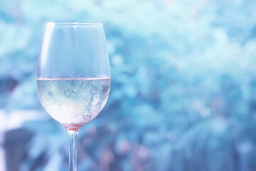 A glass of white wine on a blurred abstract background, alcohol, relaxation
