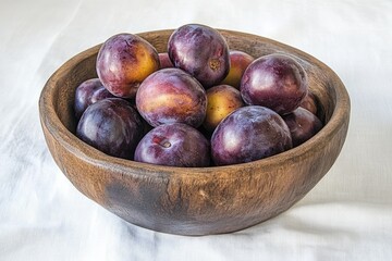 Obraz premium A rustic wooden bowl brimming with a bounty of ripe, dark purple plums.