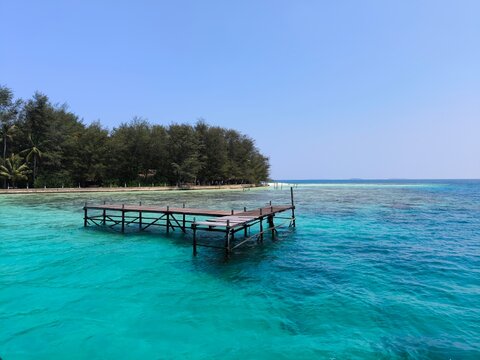 A damaged and abandoned wooden boat dock on Menjangan Island in Karimunjawa, Indonesia