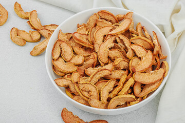 Dry pieces of apple in a bowl. Healthy food diet, vegan lifestyle, lose weight concept
