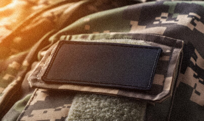 Obraz premium Close-Up of Military Camouflage Uniform with Blank Tactical Patch on Shoulder with Grainy Noise Texture futuristic dynamic poster