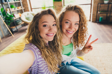 Two young women enjoying a joyful and relaxed moment at home