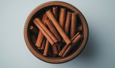 Cinnamon sticks in wooden bowl, overhead view