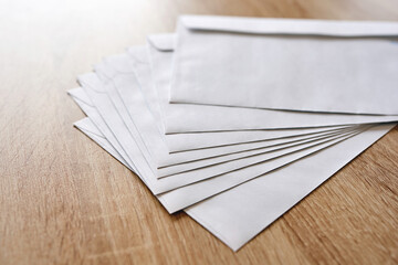 stack of white envelopes on a wooden table, Business correspondence concept