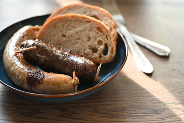 Traditional Czech dish featuring Masopust-style blood sausage (jelito) and white sausage (jitrnice), served with fresh rustic bread. 