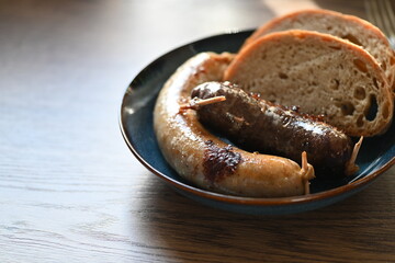 Traditional Czech dish featuring Masopust-style blood sausage (jelito) and white sausage (jitrnice), served with fresh rustic bread. 