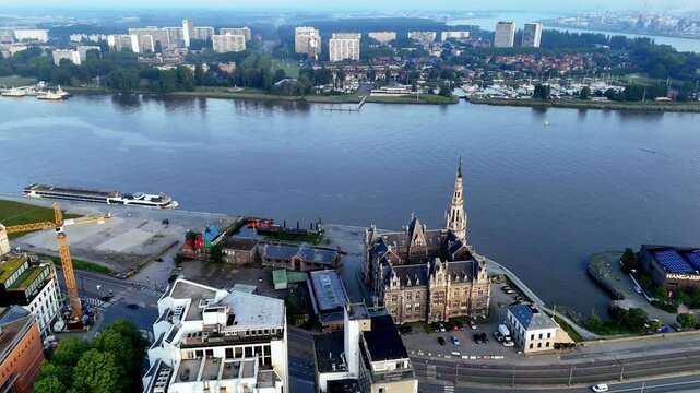 Scheldt River And Loodswezen Building In The Early Morning In Antwerp, Belgium. - aerial shot