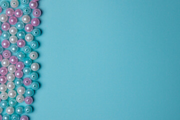 Colorful beads arranged creatively on a blue background, perfect for crafting projects and decor