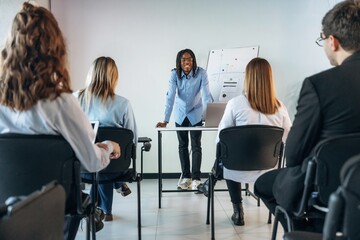 Discussion of the plan. Group of young business people are in conference room