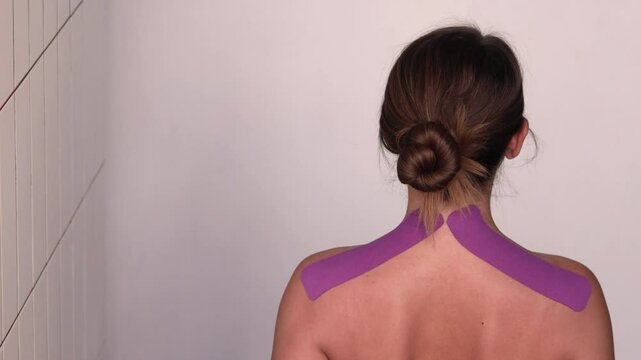 Kinesiology tape on the model's shoulders provides posture correction.