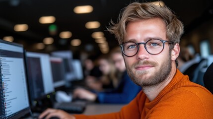 Student engaged in project work at university lab with peers collaborating nearby