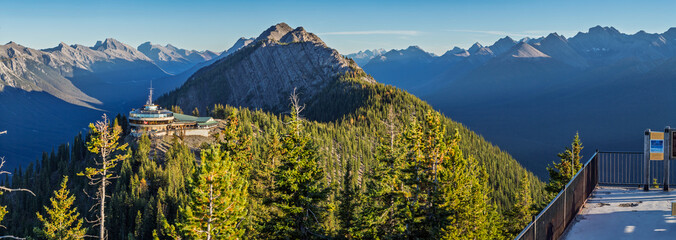 The Banff Gondola Summit offers stunning views of the Canadian Rockies. Located in Banff National Park, it features a modern observation deck, lush forests, and towering mountain peaks. © underwaterstas