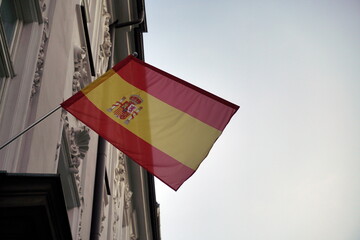spanish flag waving on building on the blue sky background