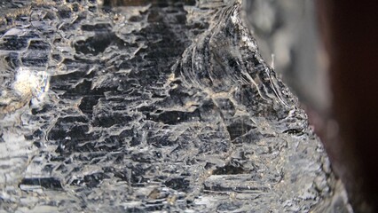 Macrophotography of the textured surface of black morion 15