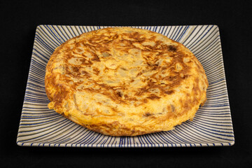 Spanish omelette on a decorative plate, showcasing traditional cuisine and delicious flavor.