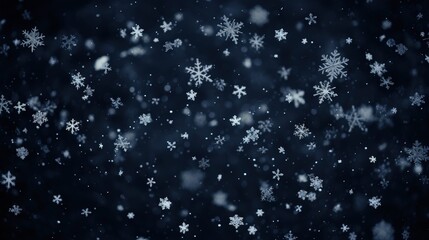 Delicate snowflakes falling gently in dark backdrop