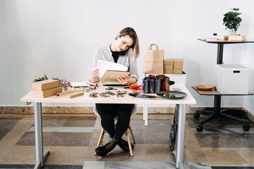 Creative entrepreneur crafting handmade jewelry in a modern workspace, balancing art and business. Handmade business, independent maker, work-life balance, productivity for creatives