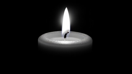 Captivating luminous candle flame radiating in solemn darkness