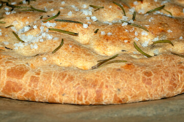 Close up of freshly baked focaccia bread  with salt and rosemary