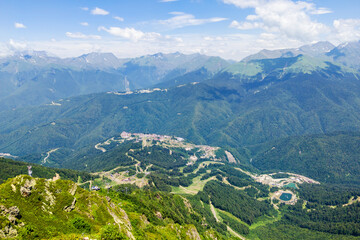 Rosa Khutor resort and mountain landscape with lush green valleys and distant snow-capped peaks,...