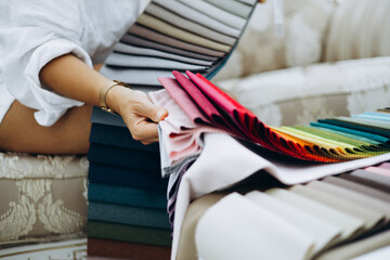 Woman choosing curtains and textile in a store