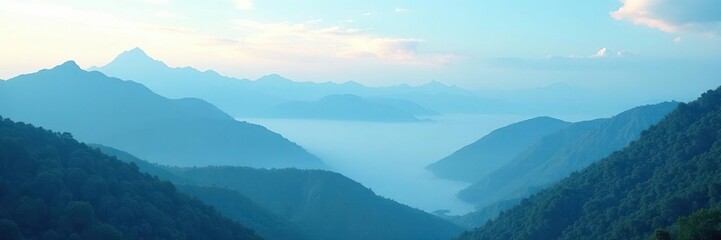 Fototapeta premium Foggy mountains meet a cerulean sky with wispy clouds, atmospheric, ethereal