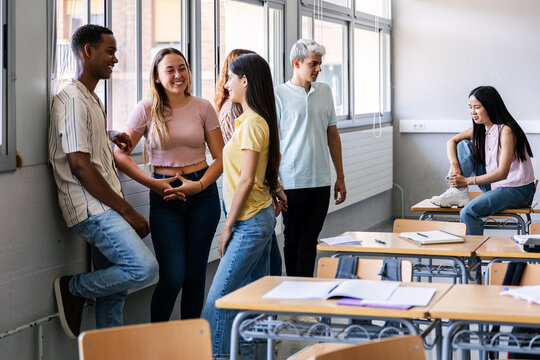 Diverse young high school students hanging out in classroom during break. Education lifestyle and youth concept