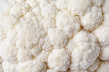 Head of organic fresh ripe white cauliflower cabbage texture macro, close up. Food background texture, vegetable wallpaper, backdrop. Healthy, diet, raw culinary ingredient.