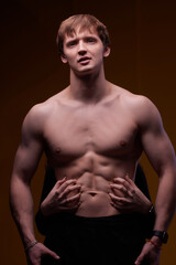 Naklejka premium Artistic Pose Displaying a Muscular Male Model That Exudes Strength and Confidence