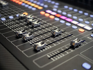 Audio mixing console, close-up. Shallow depth of field.